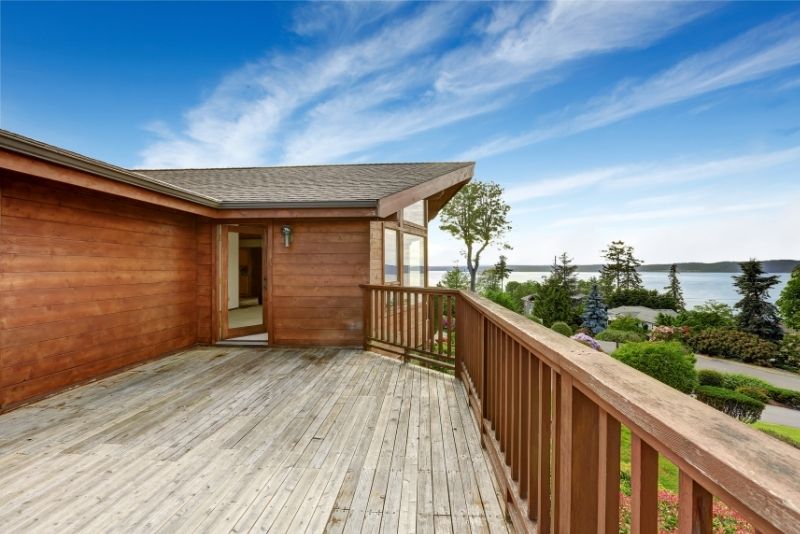 Elevated timber deck beside a home with sweeping water views