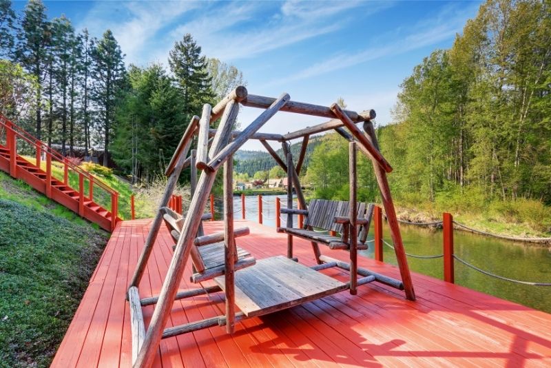 swing on decking area near the lake