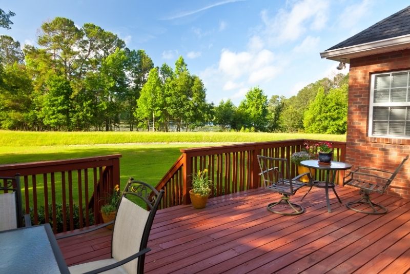 Timber deck with outdoor lounge furniture beside a house