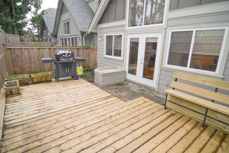 Timber deck under construction with a BBQ, garden bench and planter boxes